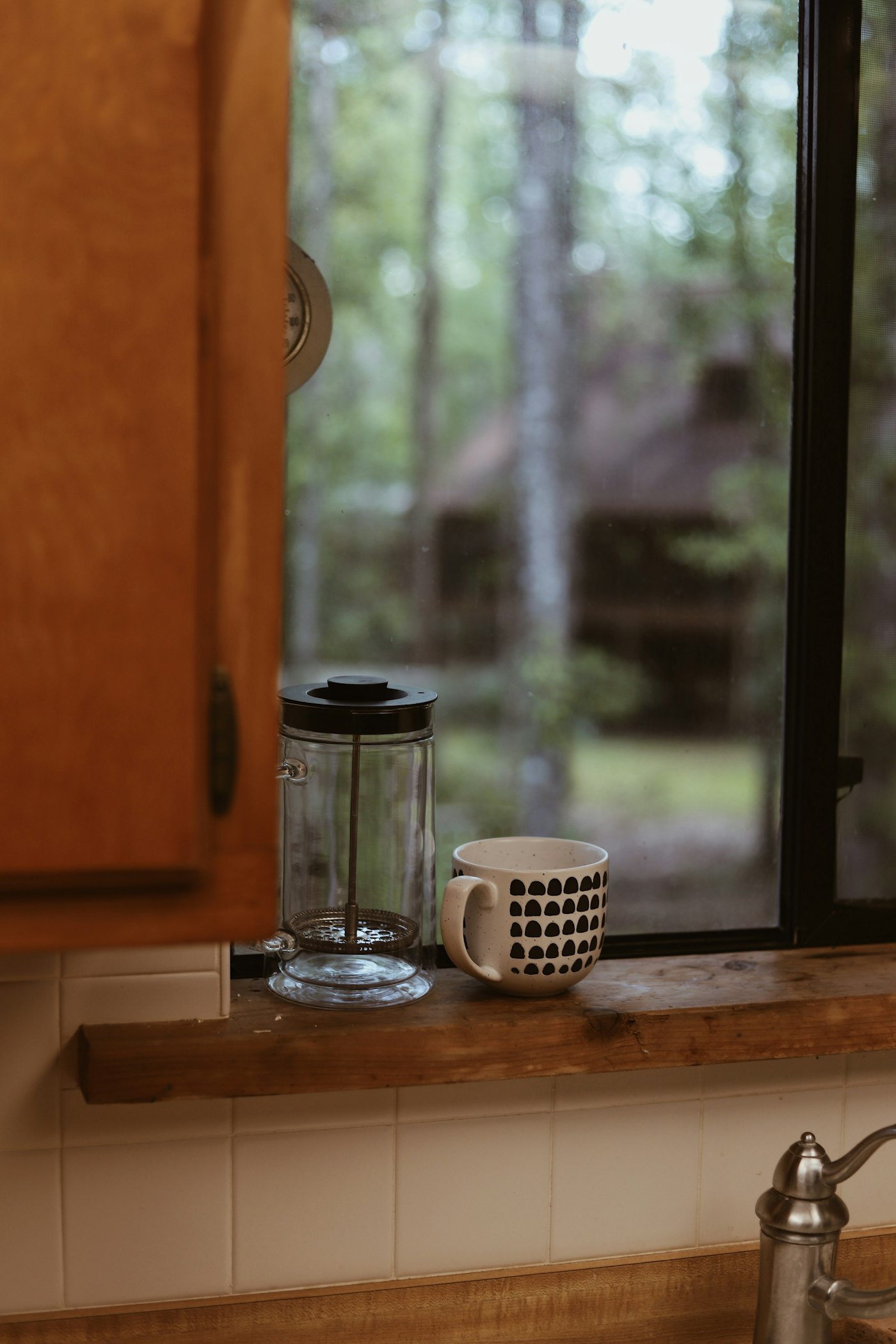 A coffee cup on the kitchenette window sill